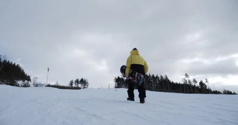 The camera captures the snowboarder climbing the mountain Stock Footage 150364525