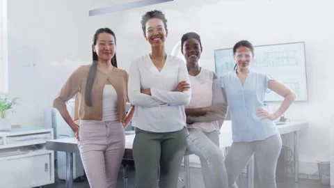 Camera capturing frames, four women shifting and smiling, zoom framing desk Stock Footage 332469508