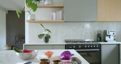Camera is capturing ingredients being placed one by one on marble kitchen island Stock Footage 343514587