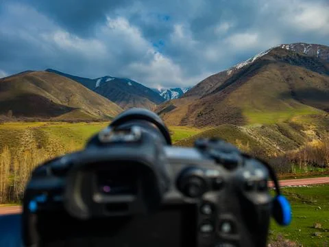 Camera capturing serene mountainous landscape during daytime Stock Photos