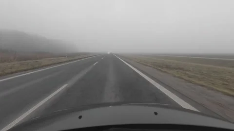 Camera on a car driving through autumn fog captures the road, vehicles with.. Stock Footage 296756109