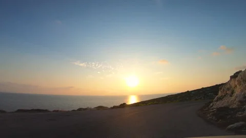 Camera car front pov driving on panoramic road by the sea in Zante at sunset Vídeo Stock 143684179