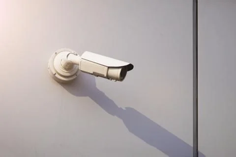 Camera CCTV on the facade of a modern office building on the street, security Stock Photos