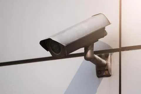 Camera CCTV on the facade of a modern office building on the street, security Stock Photos