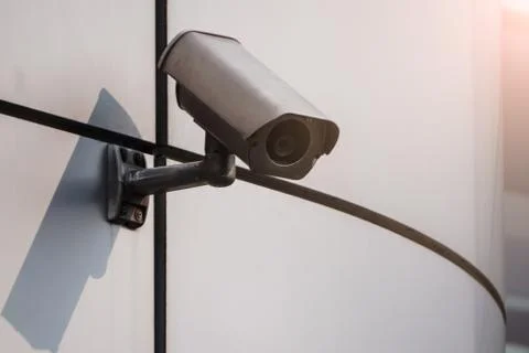 Camera CCTV on the facade of a modern office building on the street, security Stock Photos