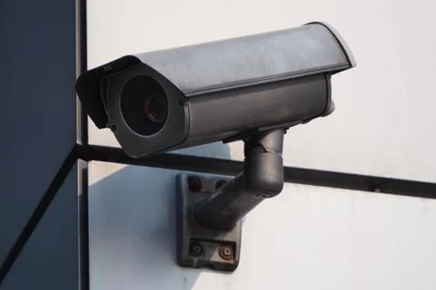 Camera CCTV on the facade of a modern office building on the street, security Stock Photos