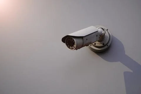 Camera CCTV on the facade of a modern office building on the street, security Stock Photos