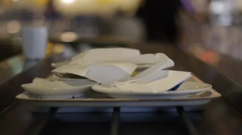 Camera centered on conveyor belt following a tray of dirty dishes Video stock 49308535