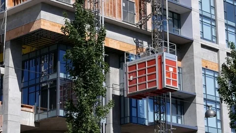 Camera chasing of construction lift of modern high rise building Stock Footage 79045816
