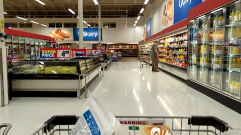Camera chasing a man buying food from Superstore's international food section Stock Footage 241146228