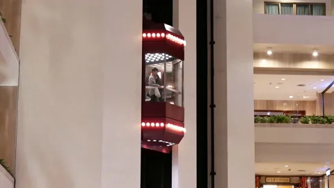 Camera chasing of people taking elevator inside the shopping mall Stock Footage 103065791