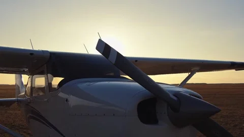 The camera circles around an airplane standing in a field. Video stock 274162562