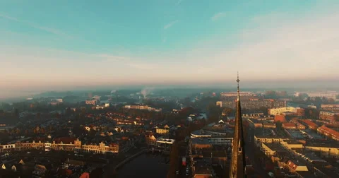 The camera circles around a cross on top of a Christian church covered in fog Video stock 63626043