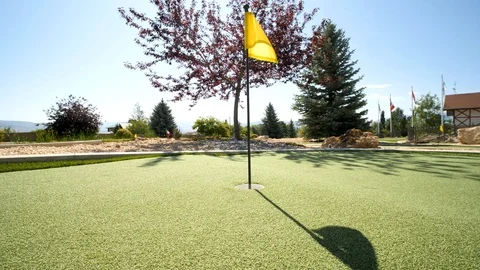 Camera circles around the golf flag and shows a boy Video stock 120251550