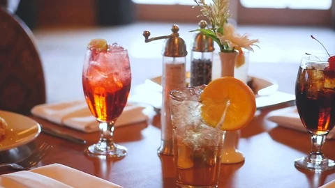 Camera circles around a set table including drinks and plated food  스톡 동영상 86441002