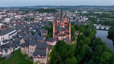 The camera circles around the tower of tourist attraction Limburg Cathedral Stock Footage 259296560