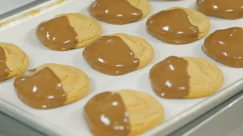 Camera circles around tray of milk chocolate dipped cookies Stock Footage 93368497