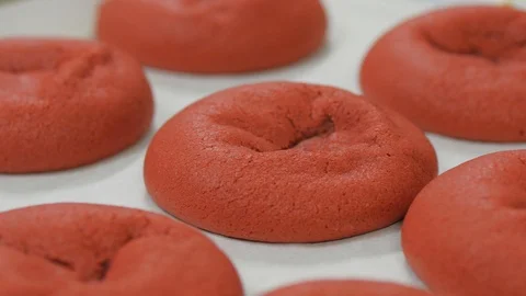 Camera circles close up on red velvet cookies on cooking tray Stock-Footage 93368328
