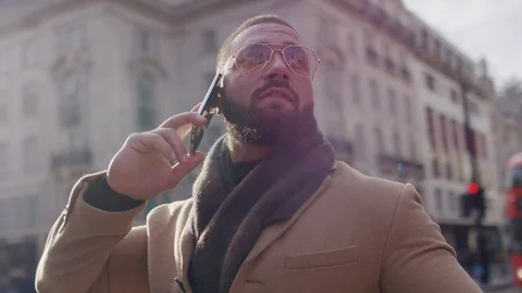 Camera circles a man on his phone in the city, in slow motion Stock Footage 120928398