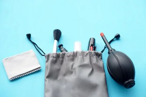 Camera cleaning kit with gray drawstring pouch, air blower, brush, lens pen and  Stock Photos