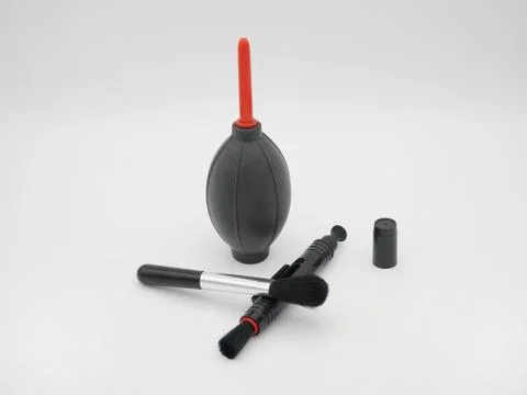 Camera cleaning set: air blower, brush and lens cleaning pen. Stock Photos