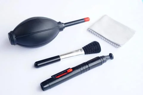 Camera cleaning tools set including air blower, lens pen, soft brush, and microf Stock Photos