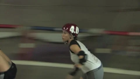 Camera close-up and wide of lone skater training, Texas Roller Derby Video stock 232957456