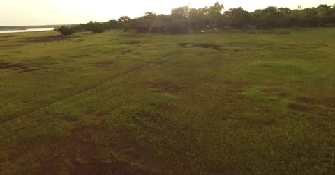 Camera is close to a large hut on a plain in Africa, Mali. Aerial drone video. N Stock Footage 65740472