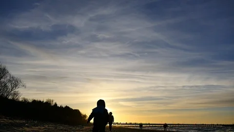 Camera closely approaching to 2 years cute boy outdoors silhouette Video stock 100290294