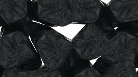 The camera closely examines the black garbage bags on a white background. Tied Stock-Footage 149768888
