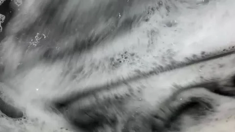 The camera closely monitors the process of washing the laundry in the washing Stock Footage 150312647