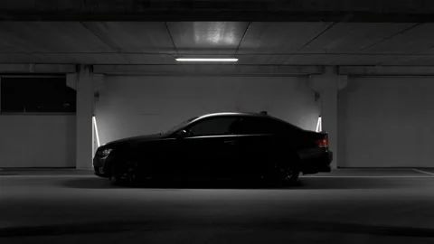 Camera closes in on a matte black BMW 325 E92 M3 M2 coupe sports car Stock Footage 145456932