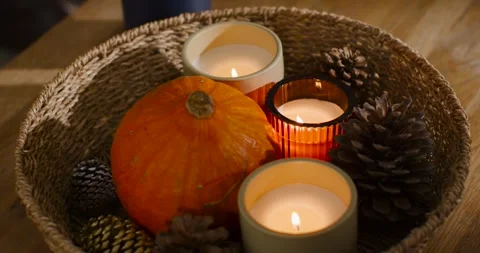 Camera is closing in as flames are flickering, casting warm glow on table Stock Footage 339252372