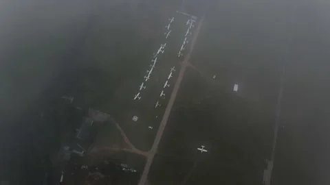 The camera comes out of the clouds to the aircraft parking lot Stock Footage 172089640