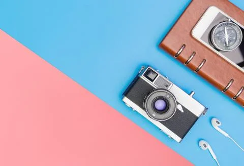 Camera compass diary on blue and yellow pink background 库存照片