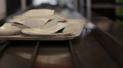 Camera on conveyor belt following an offset tray of dirty dishes Stock Footage 49413723