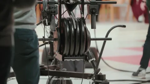 Camera crane counterweights and cable reel on indoor studio floor Stock Footage 328967417