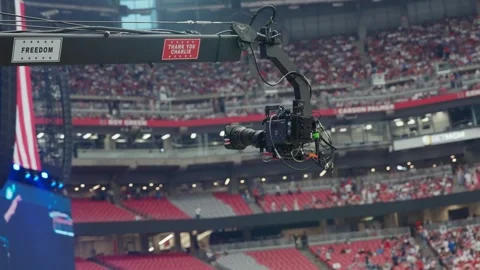 A camera crane moves above the stadium floor before the service Stock-Footage 345297942