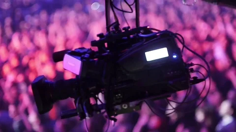 Camera crane moving over the audience in concert hall Stock Footage