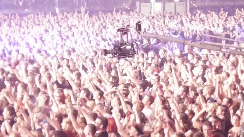 Camera crane moving over the audience of a rock show Stock Footage 73239833