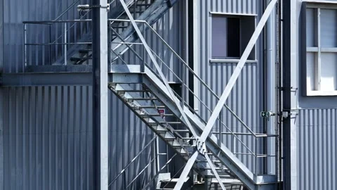 Camera Cranes Up Past Metal Staircase On Industrial Warehouse Facade Stock Footage 341542375