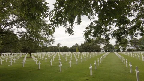 Camera cranes up to reveal rows of white crosses at the American Cemetery 스톡 동영상 111278015