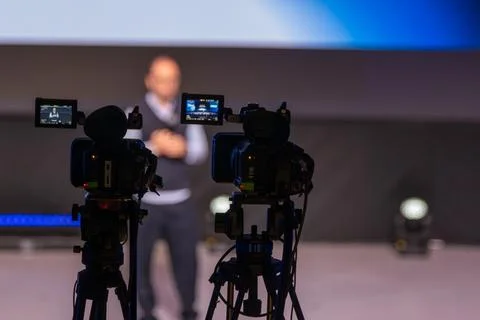 Camera Crew Captures Presenter On Stage During Live Conference With Professional Stock Photos