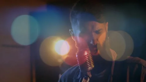 Camera cutting, drummer hitting cymbals and guitar strumming while vocalist Stock Footage 331700969