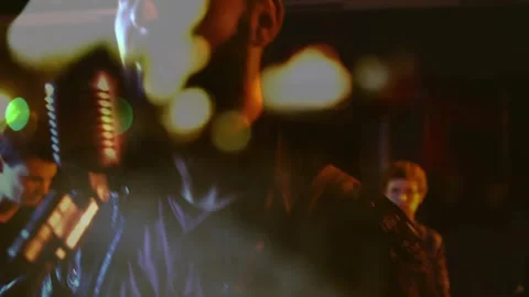 Camera cutting to four-piece rock band, lead vocalist singing into vintage mic, Stock Footage 330160359