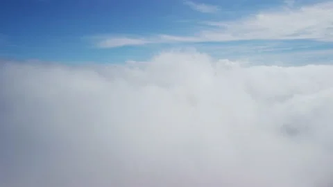 The camera descends from the thick fog above the beautiful ocean of clouds under Stock Footage 221755152