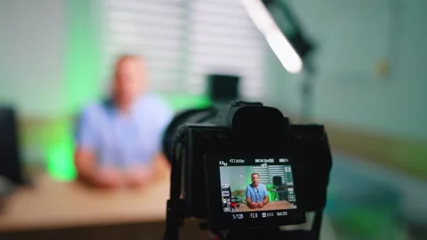 Camera display showing recording indicator during desk interview Stock Footage 335695480