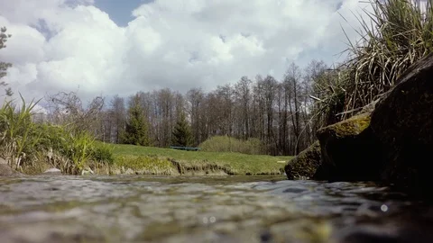 Camera dive into the water transparent stream Stock Footage 106286006