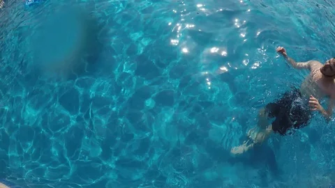 Camera dives in pool touch bottom Stock Footage 94221640