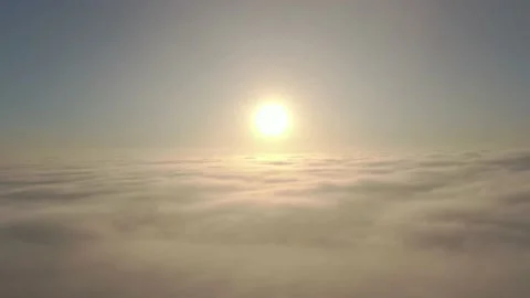 Camera diving downward into sunrise clouds towards the sun Stock Footage 144149511